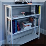 F53. White folding bookshelf. 39”H X 37”W X 12”D 